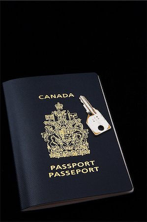 Canadian passport and key on black background Stock Photo - Premium Royalty-Free, Code: 614-08720647