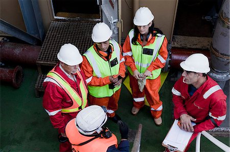 engineers consult - Engineers in brainstorming session on oil rig Stock Photo - Premium Royalty-Free, Code: 614-08720678