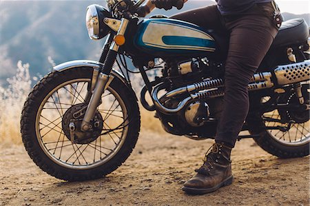 Man sitting on motorbike, low section Stock Photo - Premium Royalty-Free, Code: 614-08768431