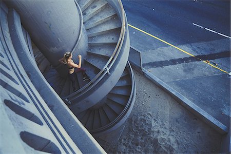 simsearch:614-09178436,k - Young woman running up spiral staircase outdoors Stockbilder - Premium RF Lizenzfrei, Bildnummer: 614-08768473