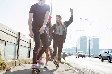 free cool people - Skateboarders walking and skateboarding together on street, Budapest, Hungary Photographie de stock - Premium Libres de Droits, Code: 614-08826937