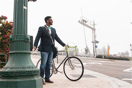 simsearch:614-08926442,k - Young man walking outdoors with bicycle Stock Photo - Premium Royalty-Free, Code: 614-08827046