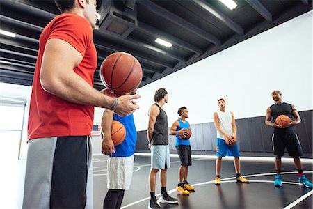 simsearch:614-08535667,k - Male trainer and basketball team practicing on court holding ball Stock Photo - Premium Royalty-Free, Code: 614-08827226