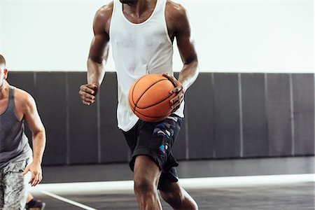 simsearch:614-08827243,k - Cropped shot of male basketball player running with ball on basketball court Stock Photo - Premium Royalty-Free, Code: 614-08827234