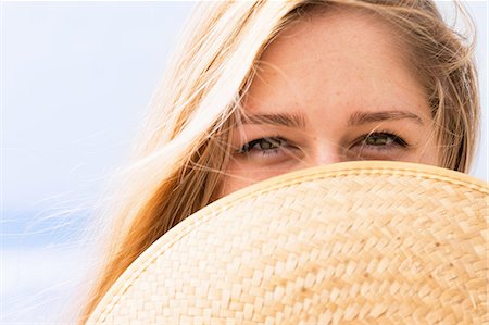 simsearch:614-07486964,k - Young woman covering face with hat Stock Photo - Premium Royalty-Free, Code: 614-08827262