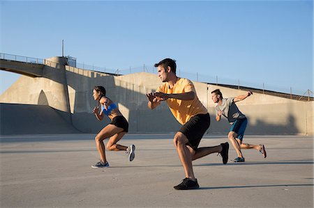 physically fit women wearing shorts - Athletes exercising in unison, Van Nuys, California, USA Stock Photo - Premium Royalty-Free, Code: 614-08821156