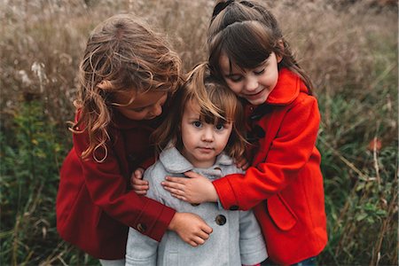 simsearch:649-09035543,k - Portrait of two girls hugging toddler sister in field Fotografie stock - Premium Royalty-Free, Codice: 614-08821437