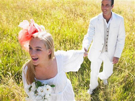 Married couple walking in a field Stock Photo - Premium Royalty-Free, Code: 614-08865462