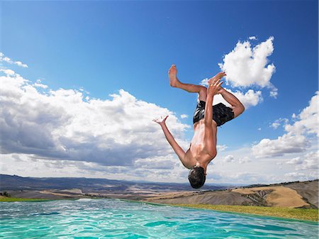 simsearch:632-06030001,k - Man jumping in swimming pool Stock Photo - Premium Royalty-Free, Code: 614-08865503