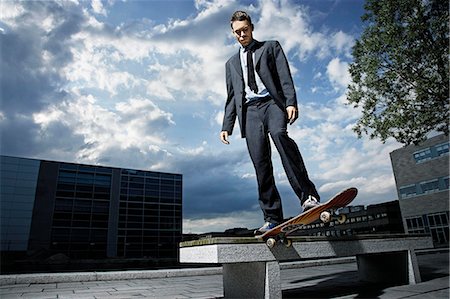 pictures of business suit and running shoes - Skateboarder showing off his skills Stock Photo - Premium Royalty-Free, Code: 614-08865537