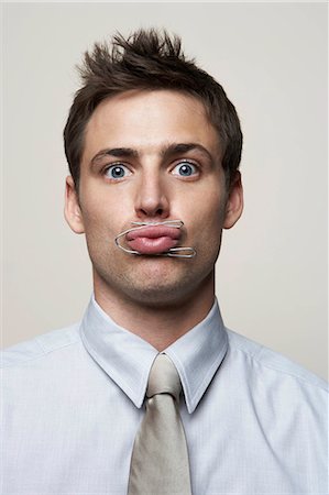 Business man with paper clip around lips Photographie de stock - Premium Libres de Droits, Code: 614-08865777