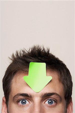 simsearch:649-03293611,k - Young man with paper arrow on head Stock Photo - Premium Royalty-Free, Code: 614-08865779