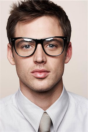 dorky businessman - Young man wearing retro glasses Stock Photo - Premium Royalty-Free, Code: 614-08865782