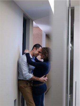 sexually excited man at office - Couple kissing in an office corridor Stock Photo - Premium Royalty-Free, Code: 614-08866041