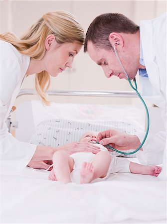 female heartbeat stethoscope - two medics tending to a child Stock Photo - Premium Royalty-Free, Code: 614-08866065
