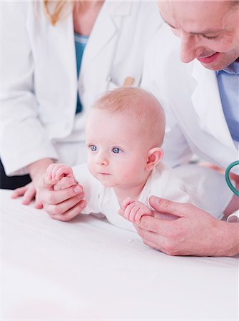 two medics tending to a baby Stock Photo - Premium Royalty-Free, Code: 614-08866068