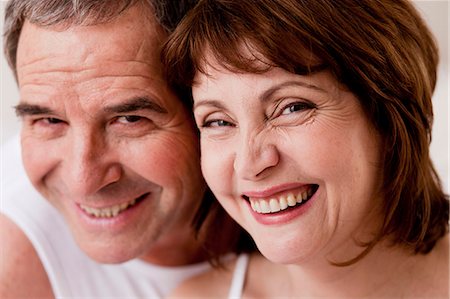 Eldery couple heads together smiling Stock Photo - Premium Royalty-Free, Code: 614-08866079