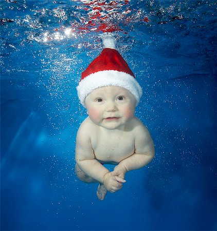 Female baby underwater with hat Stock Photo - Premium Royalty-Free, Code: 614-08866292
