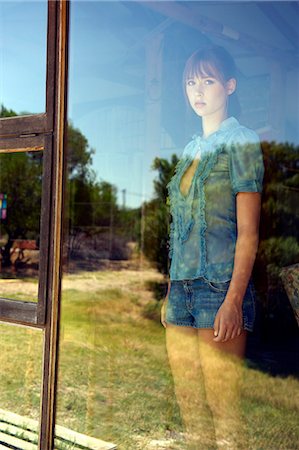 simsearch:6108-06905197,k - Teenage girl standing in window Stock Photo - Premium Royalty-Free, Code: 614-08866381