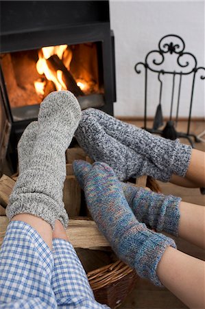 socks woman - Feet warming by the fireplace Stock Photo - Premium Royalty-Free, Code: 614-08866408