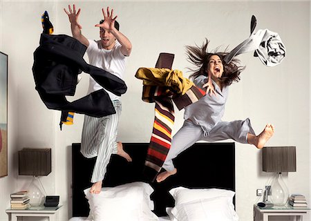 couple jumping and grabbing clothes Stock Photo - Premium Royalty-Free, Code: 614-08866457
