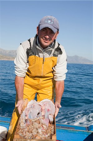 portraits of fishermen - fisherman on boat, presenting the fish Stock Photo - Premium Royalty-Free, Code: 614-08866605