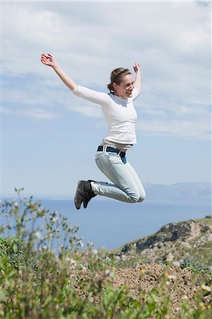 scopello - young woman jumping in air Fotografie stock - Premium Royalty-Free, Codice: 614-08866607