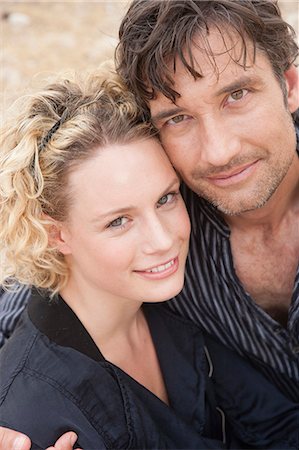 simsearch:614-08866253,k - couple embracing smiling at viewer Stock Photo - Premium Royalty-Free, Code: 614-08866862