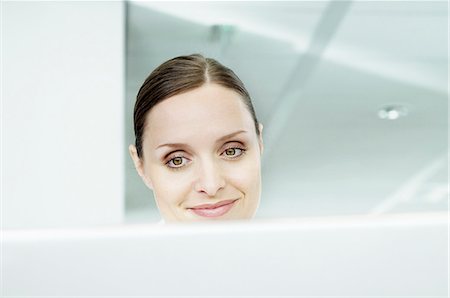 Businesswoman at laptop Stock Photo - Premium Royalty-Free, Code: 614-08867318