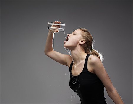 spilling water - woman drinking water Stock Photo - Premium Royalty-Free, Code: 614-08867334
