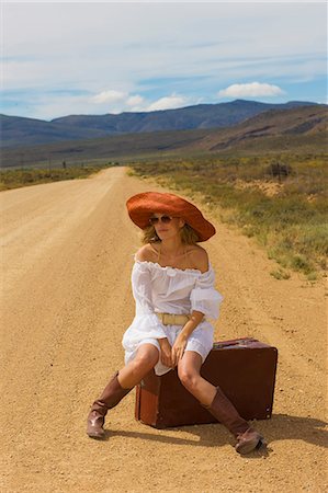 stranded - Lonely woman hitching in desert Stock Photo - Premium Royalty-Free, Code: 614-08867464