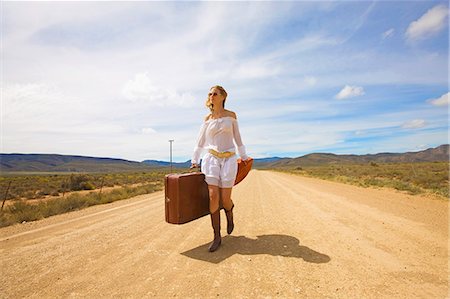 Lonely woman on desert road Stock Photo - Premium Royalty-Free, Code: 614-08867461