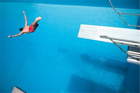 springboard - Man diving into a pool Stock Photo - Premium Royalty-Free, Code: 614-08867554