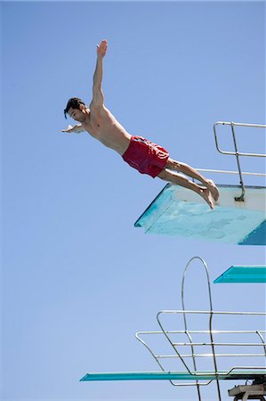 springboard - Man jumping Stock Photo - Premium Royalty-Free, Code: 614-08867558