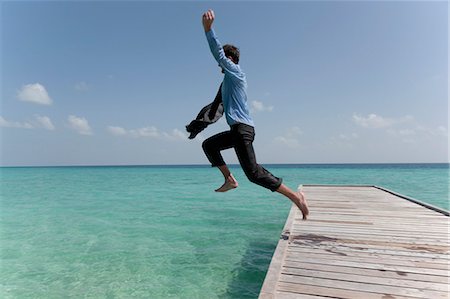 desperate - Businessman jumping from jetty into sea Stock Photo - Premium Royalty-Free, Code: 614-08867716
