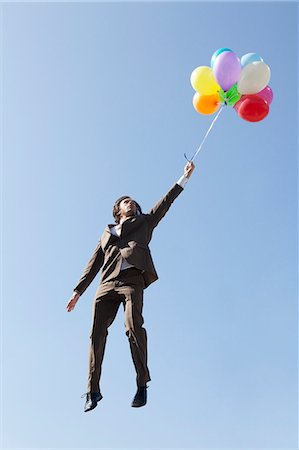 floating (person or object in air) - Businessman floating with balloons Stock Photo - Premium Royalty-Free, Code: 614-08867762