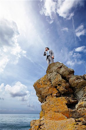 simsearch:649-08307019,k - Businessman on cell phone on cliff Stock Photo - Premium Royalty-Free, Code: 614-08867825