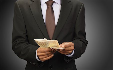 simsearch:614-00397700,k - Businessman counting euros Foto de stock - Sin royalties Premium, Código: 614-08867844