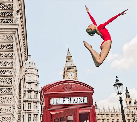 Gymnast leaping from telephone booth Photographie de stock - Premium Libres de Droits, Code: 614-08867974