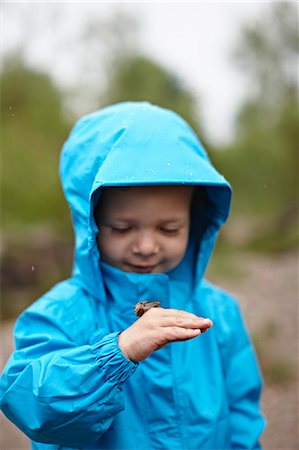 Toddler boy playing with insect outdoors Stock Photo - Premium Royalty-Free, Code: 614-08868003