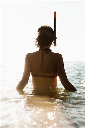 Woman wearing snorkel in water Stock Photo - Premium Royalty-Free, Code: 614-08868177