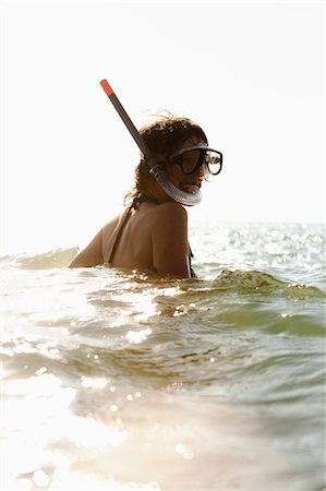 Woman wearing snorkel in water Stock Photo - Premium Royalty-Free, Code: 614-08868178