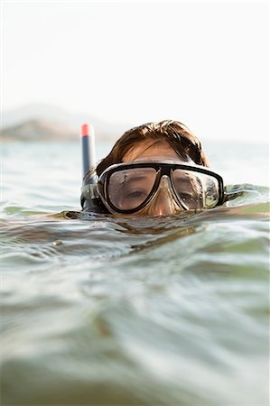 Woman wearing snorkel in water Stock Photo - Premium Royalty-Free, Code: 614-08868179