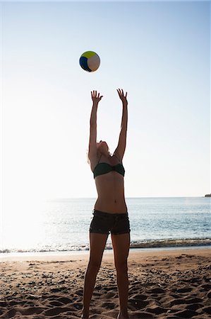 sport bathing suits for volleyball - Woman playing with volleyball on beach Stock Photo - Premium Royalty-Free, Code: 614-08868190