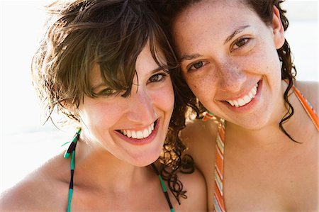 Women in bikinis smiling together Stock Photo - Premium Royalty-Free, Code: 614-08868192