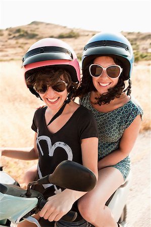 simsearch:6102-07843643,k - Smiling women riding scooter together Photographie de stock - Premium Libres de Droits, Code: 614-08868215