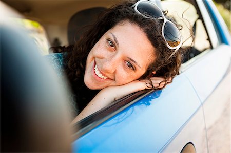 Woman smiling in car Stock Photo - Premium Royalty-Free, Code: 614-08868212