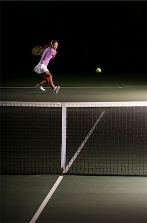 simsearch:649-08560912,k - Woman playing tennis indoors Stock Photo - Premium Royalty-Free, Code: 614-08868386