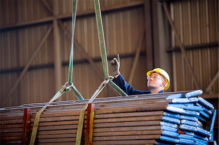 simsearch:841-08244119,k - Worker signaling crane at shipyard Stock Photo - Premium Royalty-Free, Code: 614-08868468