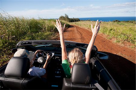 Women driving convertible on dirt road Stock Photo - Premium Royalty-Free, Code: 614-08868480